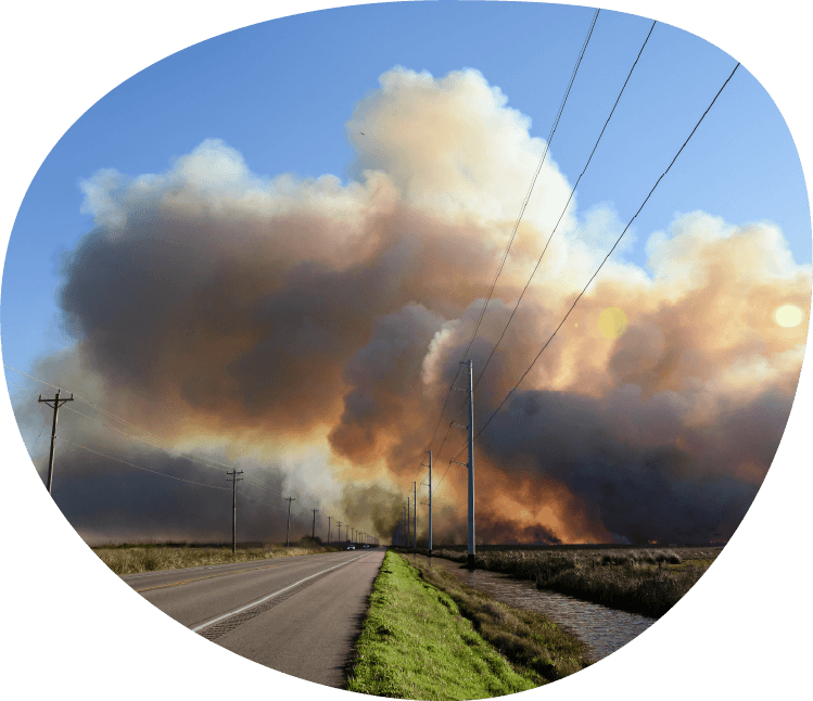 Smoke clouds polluting moving in the sky over a long road