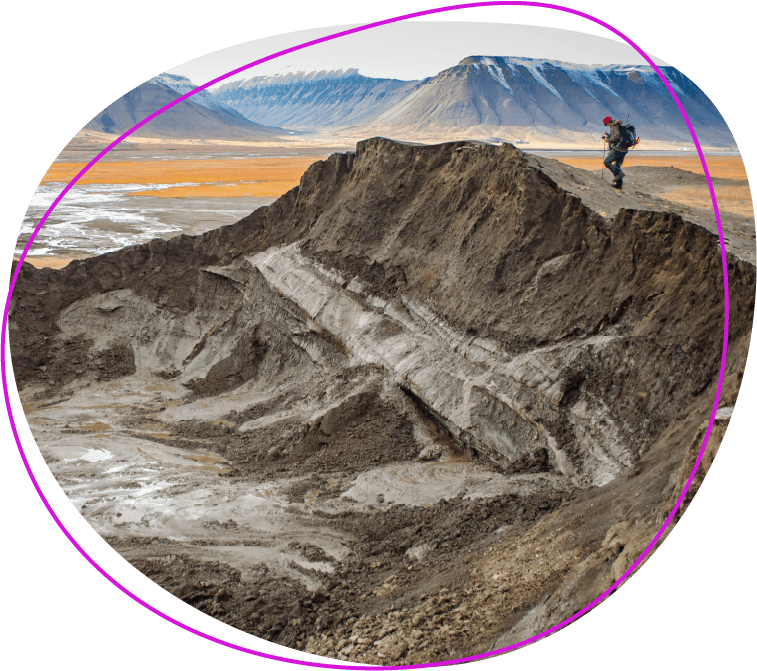 Explorer on top of burst pingo in a permafrost Arctic landscape